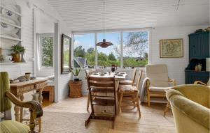 a dining room with a table and chairs at Stunning Home In Thyholm With Kitchen in Thyholm