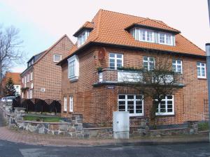 a large brick house with a red roof at Ferienwohnung Möwe in Heiligenhafen