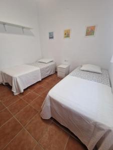 Łóżko lub łóżka w pokoju w obiekcie Casa Alma