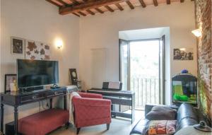 a living room with a couch and a television and a keyboard at Amazing Apartment In Montefortino With Wifi And 2 Bedrooms in Montefortino