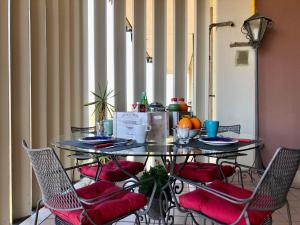 - une table avec des chaises et une table avec de la nourriture dans l'établissement Bellini Garden View, à Catane