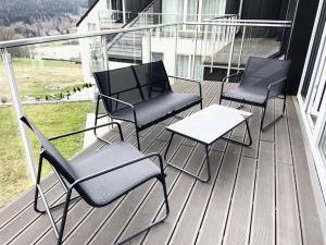 three chairs and a table on a porch at Blueberry Mountain Czarna góra in Biała Woda +3 photos