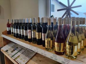 Weingut Lieschnegg في ليوتسشاخ: مجموعة من زجاجات النبيذ على رف