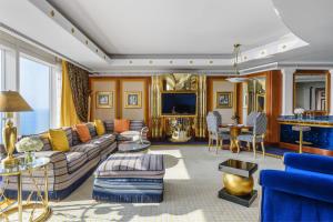 a living room with a couch and a tv at Burj Al Arab Jumeirah in Dubai