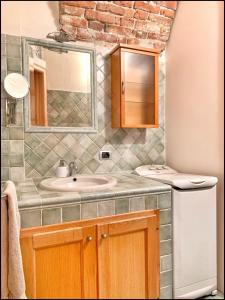 a bathroom with a sink and a mirror at La Fiaba: bilocale nel centro storico di Cuneo in Cuneo
