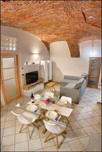 a living room with a glass table and chairs at La Fiaba: bilocale nel centro storico di Cuneo in Cuneo