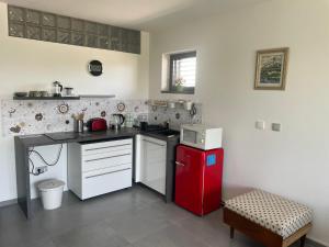 a kitchen with a red refrigerator and white cabinets at Ubytování U Vinice in Mělník
