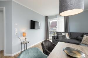 a living room with a couch and a table at Sturmfrei Suite 8 in Scharbeutz
