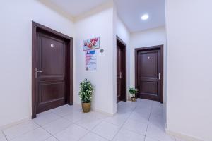 a hallway with two doors and plants in a building at الياسمين in Jeddah