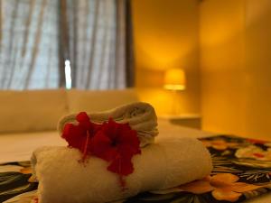 a white towel with a red flower on it at Libby's Vacation Rental 2 Bed Home 1-4 Guests in Nadi