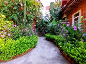 a garden with flowers and plants on a building at Ninh Binh Mountain Side Homestay & Cafe in Ninh Binh