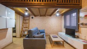 a living room with a couch and a tv at La Casa de Gigantones by Toledo AP in Toledo