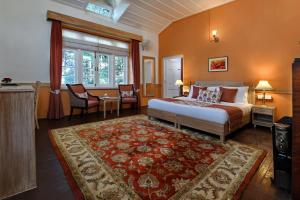 a bedroom with a bed and a table and chairs at Brij Villa, Dalhousie - A Colonial Luxury Retreat in Dalhousie