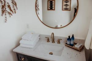 a bathroom with a sink and a mirror at The Shasta Cottage in Klamath Falls