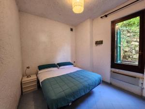 a bedroom with a bed in a room with a window at Baia dei Colori in Cure +30 photos
