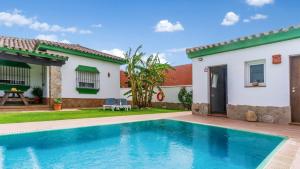 a villa with a swimming pool in front of a house at Villa Sonrisa Chiclana de la Frontera by Ruralidays in Chiclana de la Frontera