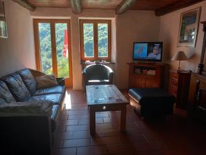 a living room with a couch and a coffee table at Casa Tita in Intragna