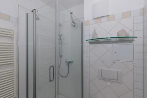 a bathroom with a shower with a glass door at Villa-Parkblick-Wohnung-26-541 in Kühlungsborn