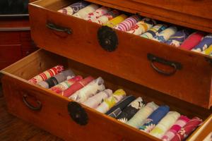 a wooden box filled with different colored candles at Iroriyado Hidaya in Takayama