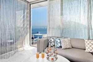 a living room with a couch and a table at Jumeirah Burj Al Arab Dubai in Dubai
