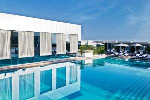 a swimming pool with chairs and a building at Jumeirah Burj Al Arab Dubai in Dubai