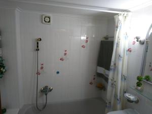 a bathroom with a shower with a shower curtain at Sunny family apartment in Chania close to the sea in Chania Town