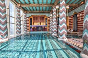 a pool in the middle of a room with a tile floor at Jumeirah Burj Al Arab Dubai in Dubai