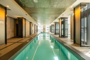 a swimming pool in a building with an empty at Modern Lillian St Apartments by GLOBALSTAY in Toronto