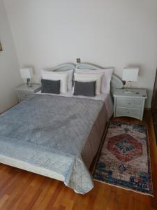 a bedroom with a large bed with two night stands at Sunny family apartment in Chania close to the sea in Chania