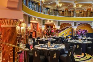 a banquet hall with tables and chairs and flowers at Jumeirah Burj Al Arab Dubai in Dubai