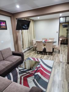 a living room with a couch and a table at Departamentos Amoblados Tacna Heroica in Tacna