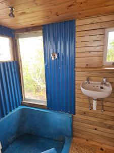 a bathroom with a sink and a bath tub at Aintree Lodge - Yoga Den in Langebaan