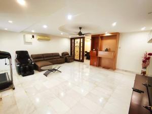 a large living room with a couch and a tv at Puchong Landed Homestay - 1st unit @ BKT Puchong in Puchong