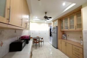 a kitchen with a table and a ceiling fan at Puchong Landed Homestay - 1st unit @ BKT Puchong in Puchong
