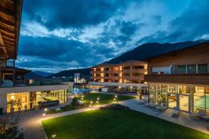 a view of the courtyard of a hotel at night at Alpine Nature Hotel Stoll in Valle Di Casies