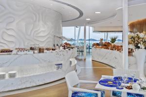 a restaurant with tables and chairs and a counter at Jumeirah Burj Al Arab Dubai in Dubai