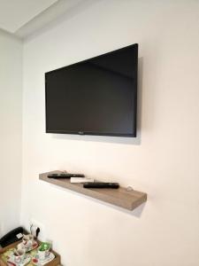 a flat screen tv hanging on a wall at Hotel & Spa Villa Meydan in Mostar