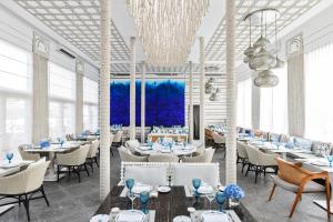 a rendering of a restaurant with tables and chairs at Jumeirah Burj Al Arab Dubai in Dubai