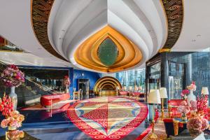 a lobby with a red and blue carpet and a large ceiling at Burj Al Arab Jumeirah in Dubai