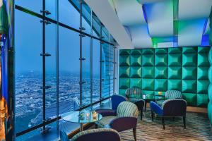 a restaurant with tables and chairs and a view of the ocean at Jumeirah Burj Al Arab Dubai in Dubai