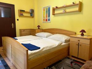 a bedroom with a wooden bed with a blue towel on it at Penzión Encián in Blatnica