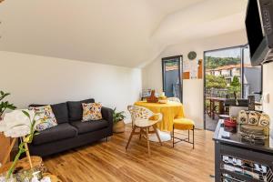 a living room with a couch and a table at Cork House - Fernandes Cottage in Ponta Delgada