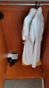 a pile of towels sitting on top of a shelf at Hotel Duke Romana in Bucharest