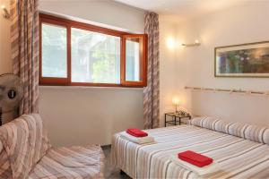 a bedroom with a bed and a window at WELLNESS VERSILIA -SAUNA & JACUZZI- Free Parking- in Marina di Massa