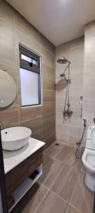 a bathroom with a sink and a toilet at The Blue House in Da Lat