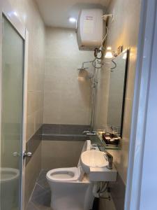 a small bathroom with a toilet and a sink at The Blue House in Da Lat +50 photos
