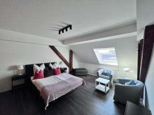a bedroom with a large bed with pink pillows at Hotel Restaurant Goldenes Ross in Göllheim