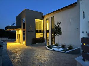 a building with a driveway in front of it at AKROTHEA suites & lounge in Tripoli