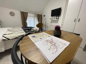 a room with a table with a bed and a drawing on it at My Studio Pr in Pristina