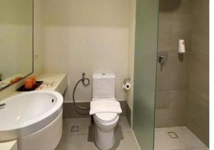 a bathroom with a white toilet and a sink at Go Hotels Plus Mandaluyong in Manila